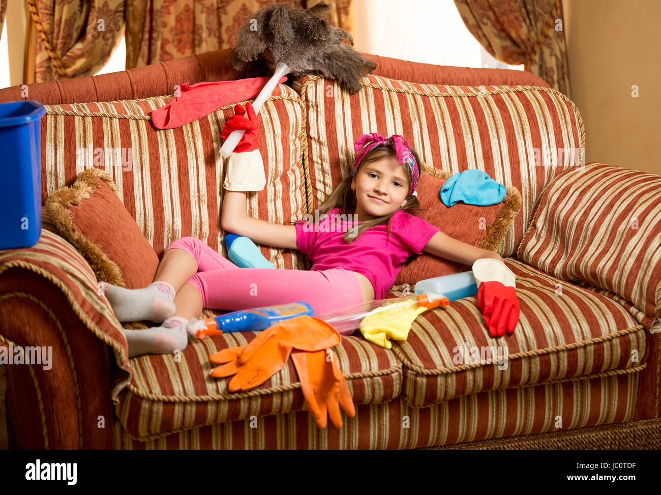 Funny photo of exhausted girl relaxing on sofa after cleaning house Stock  Photo - Alamy