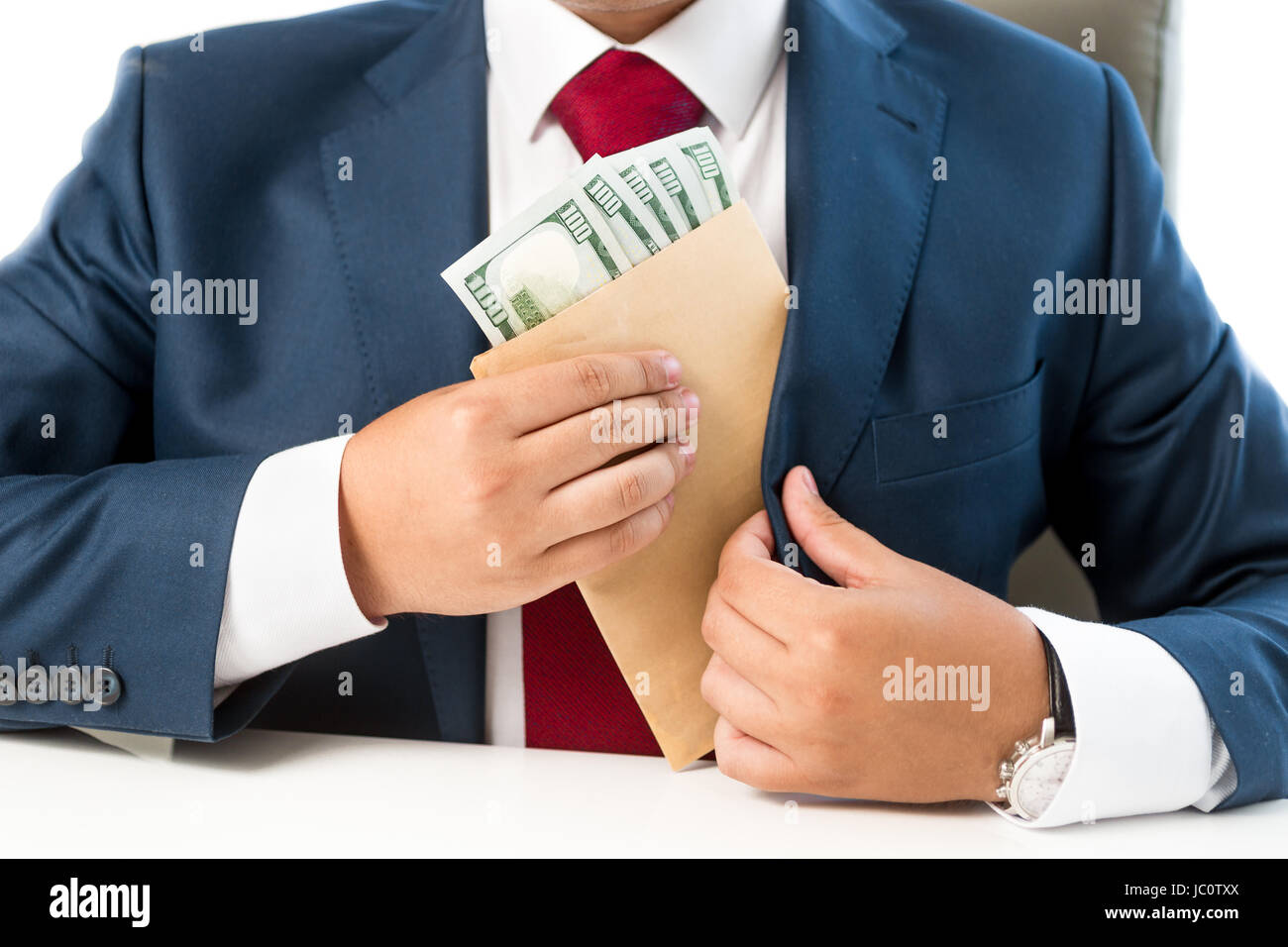 Closeup conceptual photo of bribed man putting money in the suit pocket Stock Photo