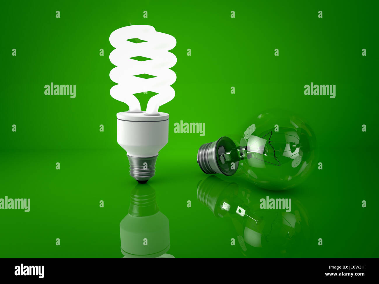 Glowing energy saving bulb and dark incandescent bulb over green ...