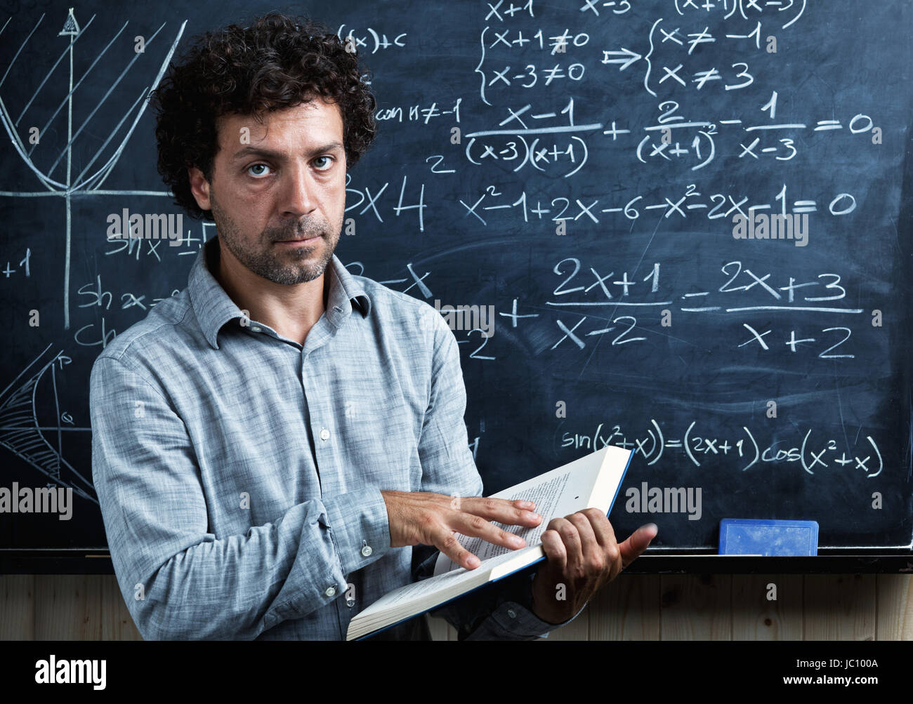 portrait of caucasian teacher and blackboard background Stock Photo