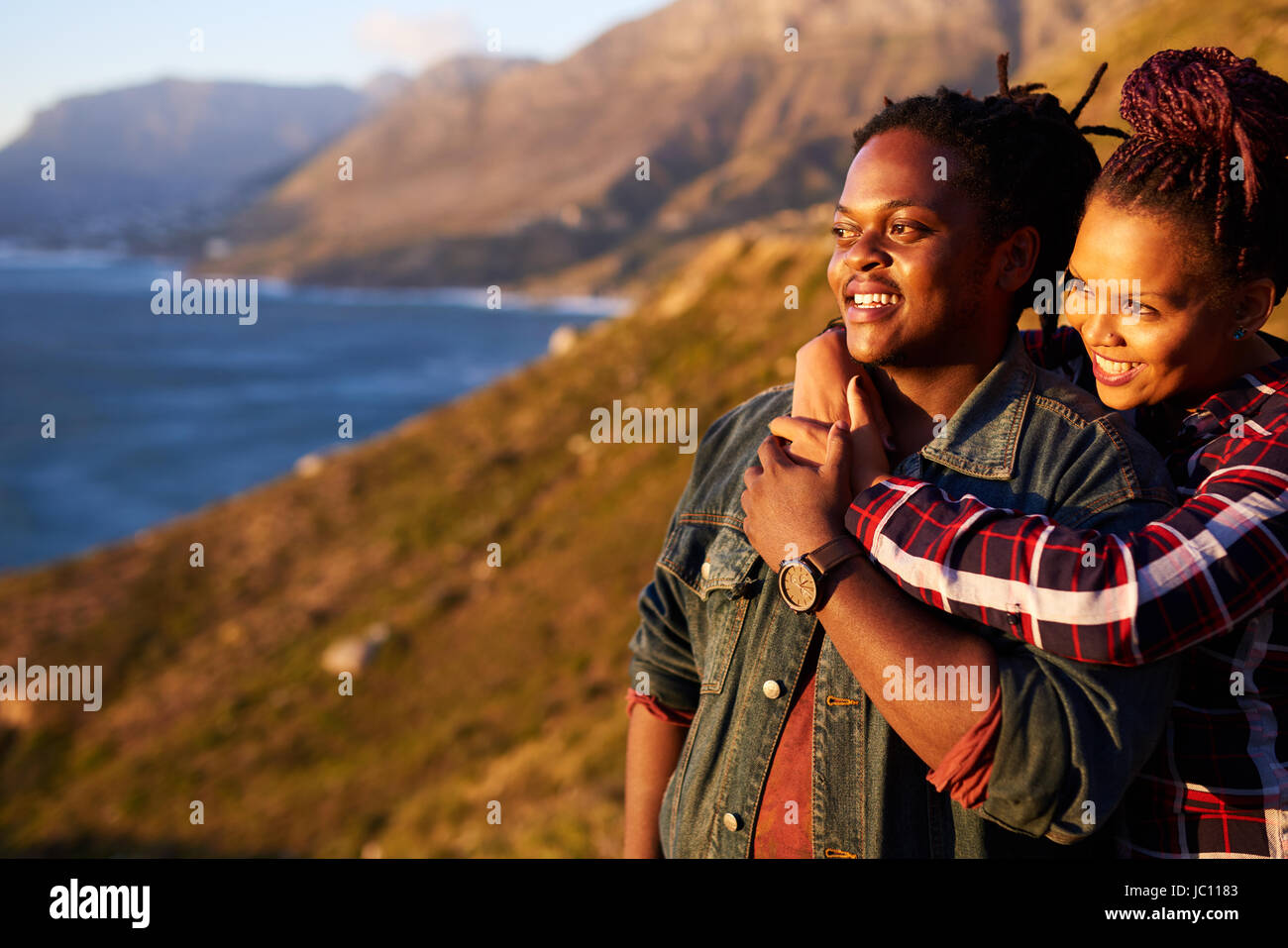 Mixed race couple looking out towards the view outdoors together Stock Photo
