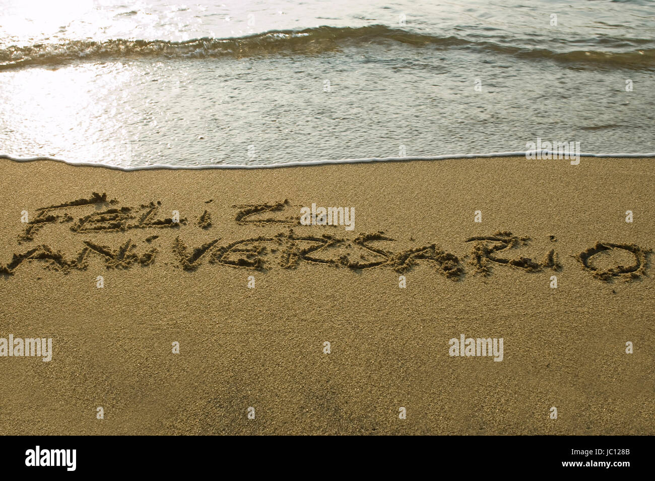 cogratulation sentence on the sand of a beach Stock Photo