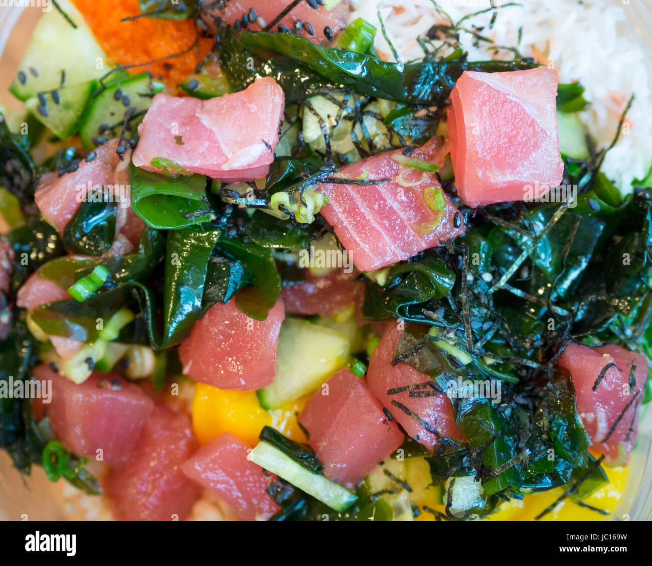 A close-up of a delicious Ahi Poke Bowl (Hawaiian raw fish salad) from Splash Poke in Edmonton, Alberta, Canada. Stock Photo
