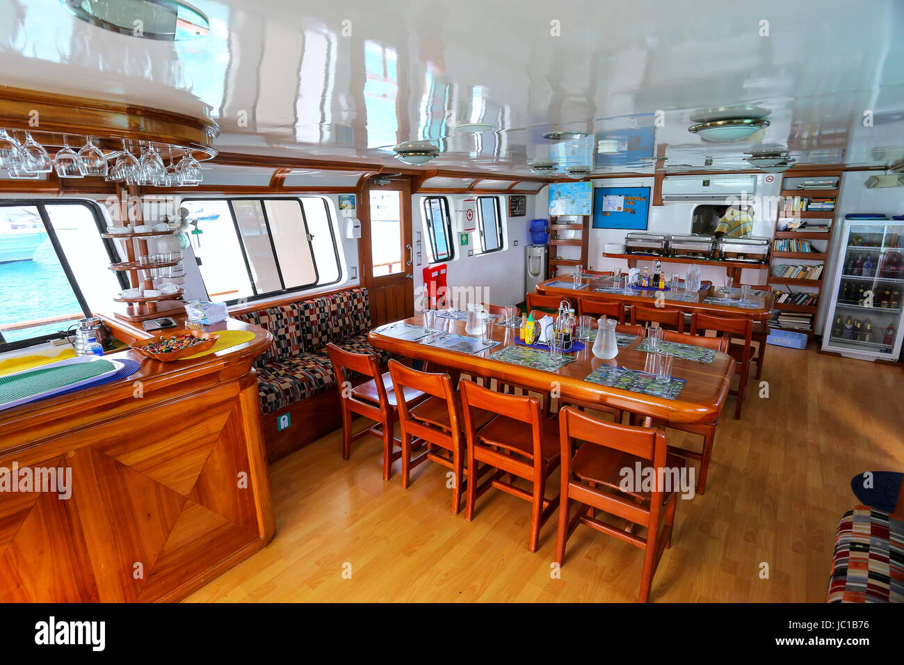 Typical lounge area inside tourist yacht in Galapagos National Park, Ecuador. Tourist yachts are the main way to see islands of the park. Stock Photo