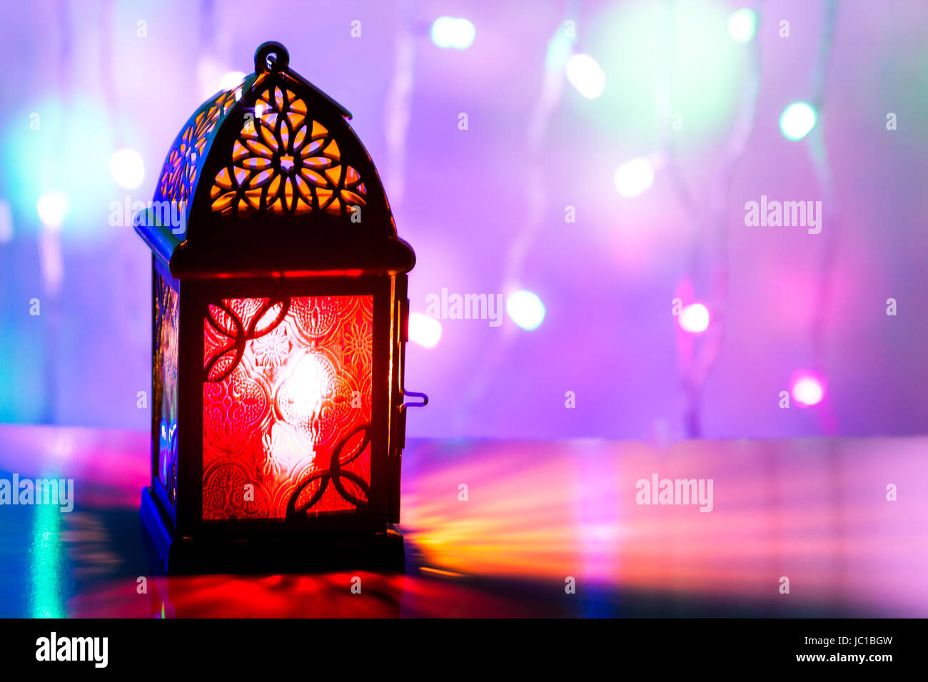 Illuminated Arabic lantern in colorful background. Ramadan 