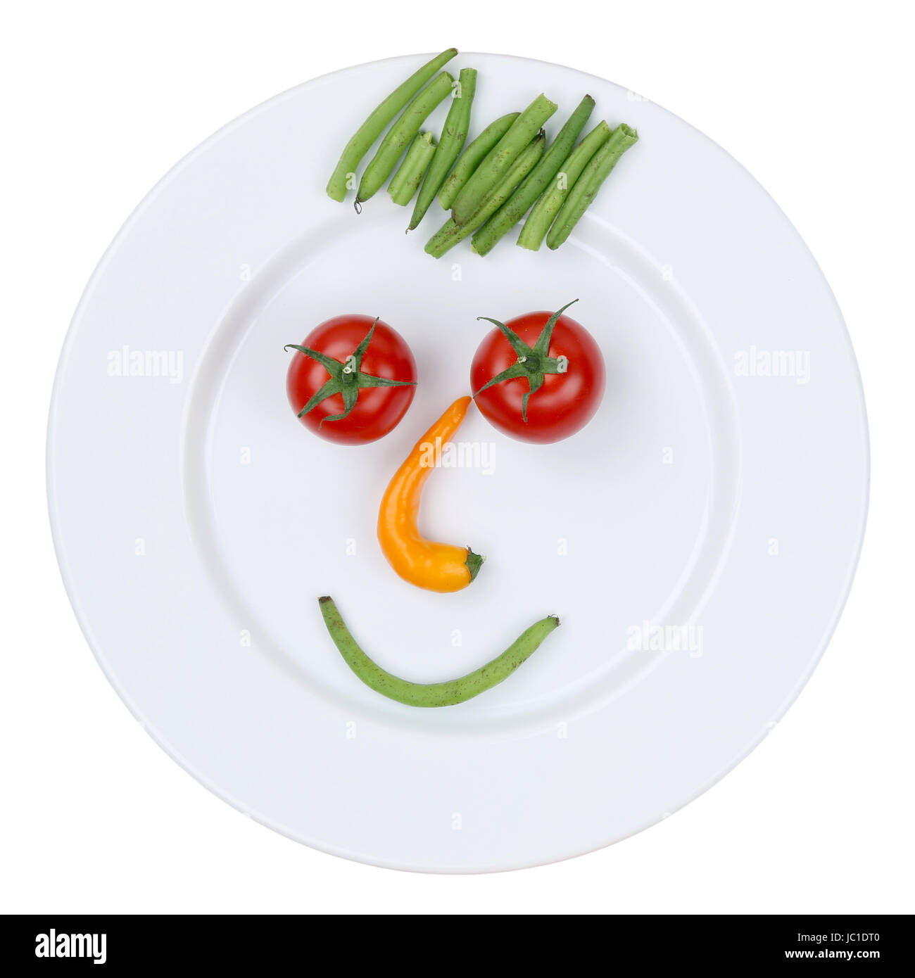 Gesunde vegetarische Ernährung Gesicht aus Gemüse auf Teller freigestellt Stock Photo