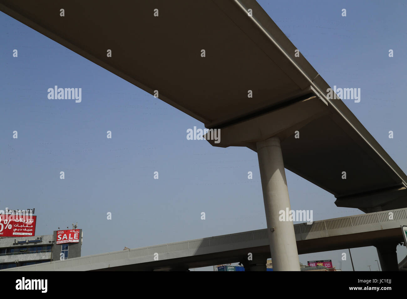 Elevated Metro Track crossing flyover in highway - Dubai Metro Stock Photo