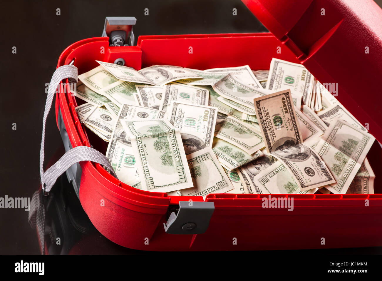 A Suitcase with lots of dollars Stock Photo Alamy