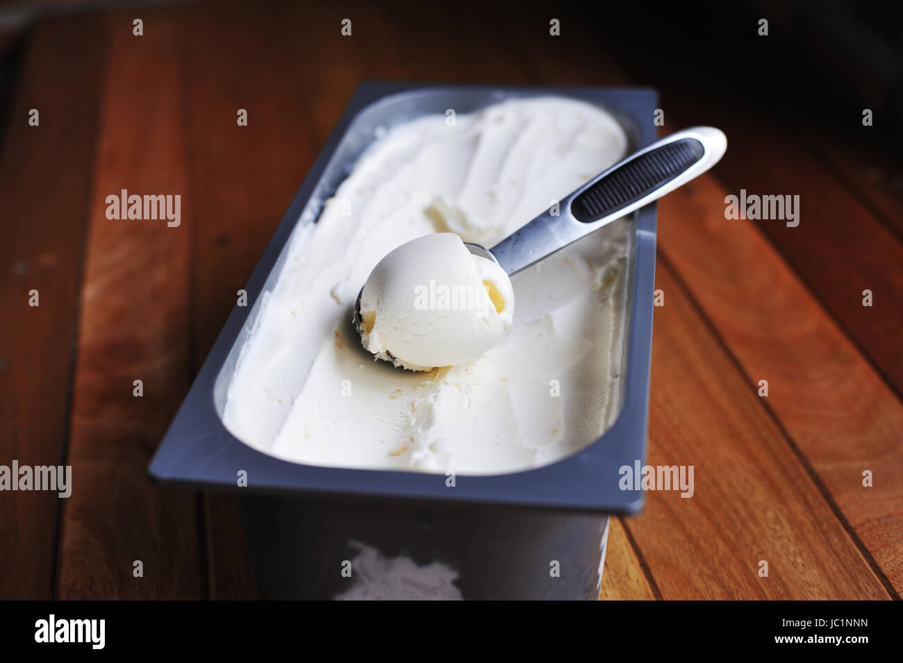 Homemade Organic Vanilla ice cream scoop, scooped out of a container
