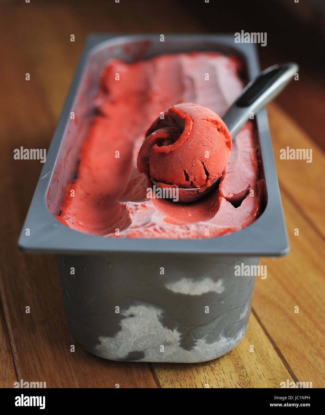 Homemade Organic Strawberry fruit ice cream scoop, scooped out of a