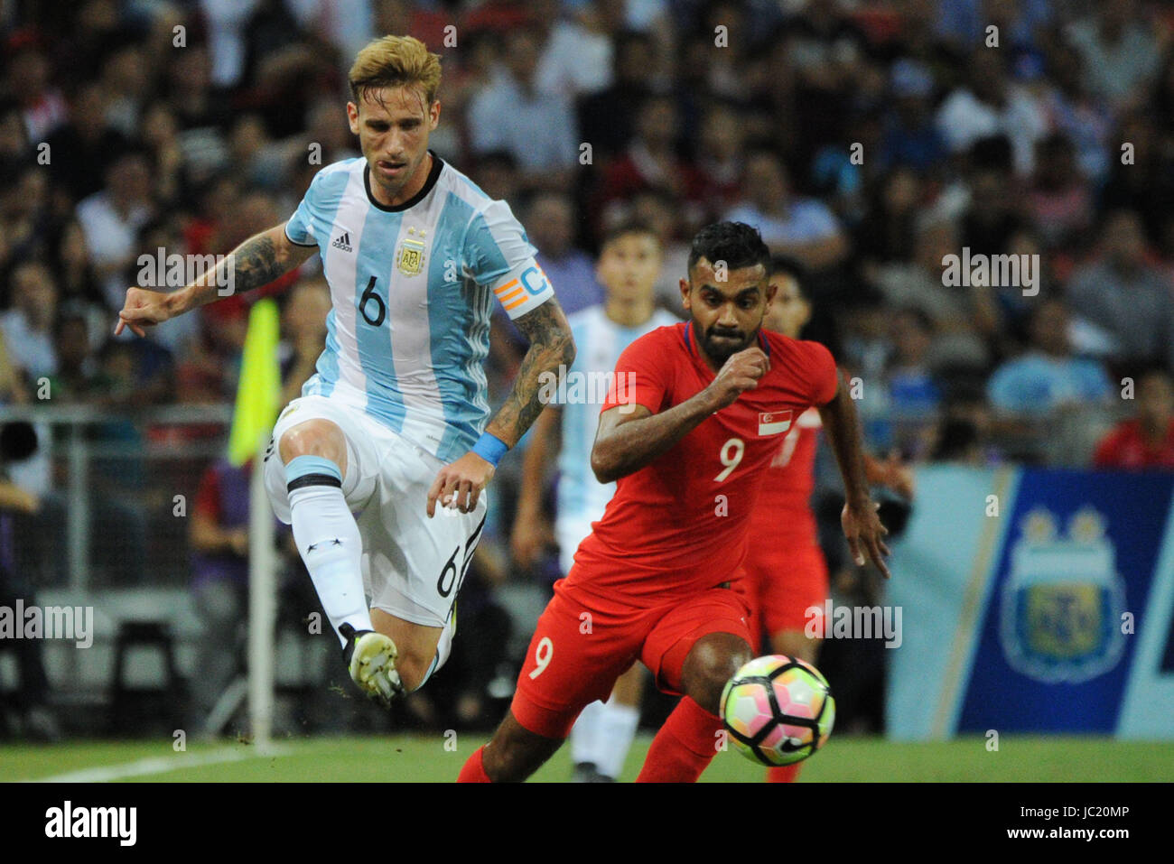 Singapore. 13th June, 2017. Argentina's player Lucas Biglia (L) competes during the international friendly match between Singapore and Argentina held in the National Stadium of Singapore on Jun 13, 2017. Credit: Then Chih Wey/Xinhua/Alamy Live News Stock Photo