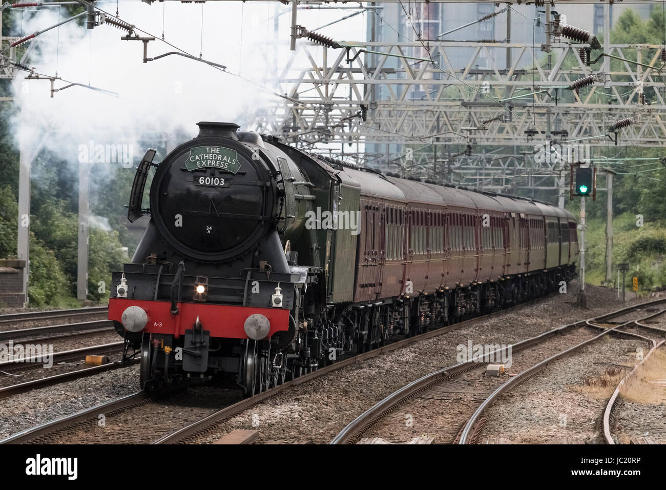 Rugeley, Staffordshire, UK. 13th Jun, 2017. Preserved British Rail A3 Pacific steam locomotive 'Flying Scotsman' passes through Rugeley Trent Valley station working the Cathedrals Express railway charter from London Victoria to Chester, on the 13th June 2017. The locomotive is generally seen as the most famous steam engine in the world, having been the first steam locomotive to officially reach 100mph. Credit: Richard Holmes/Alamy Live News Stock Photo