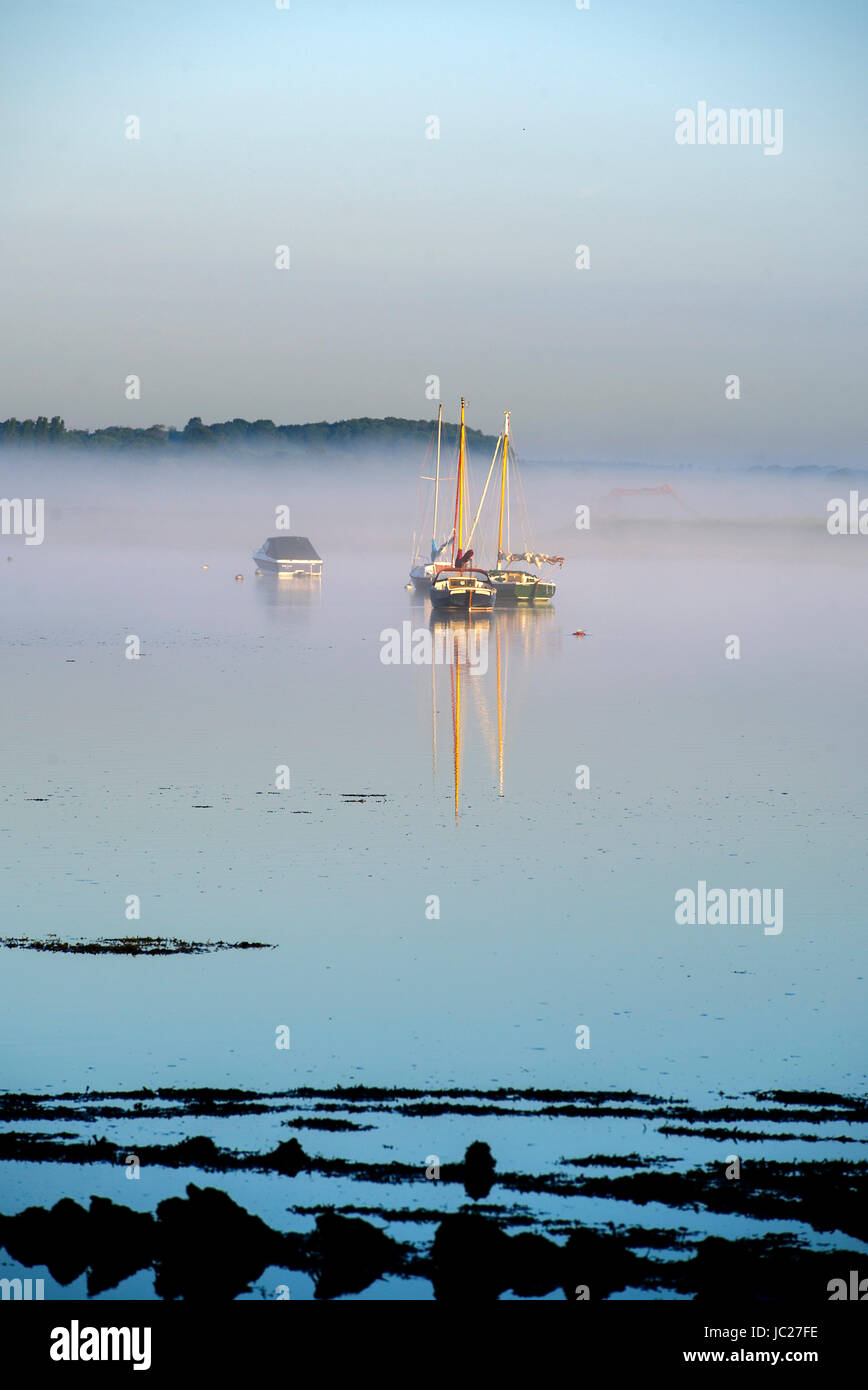 Aldeburgh Suffolk, UK. 14th June, 2017. An early morning mist is burnt off by the sun over the River Alde estuary at Aldeburgh on the Suffolk coast . Hot sunny weather is forecast to spread across Britain again in the next few days with temperatures reaching as high as 28 degrees in some parts Credit: Simon Dack/Alamy Live News Stock Photo