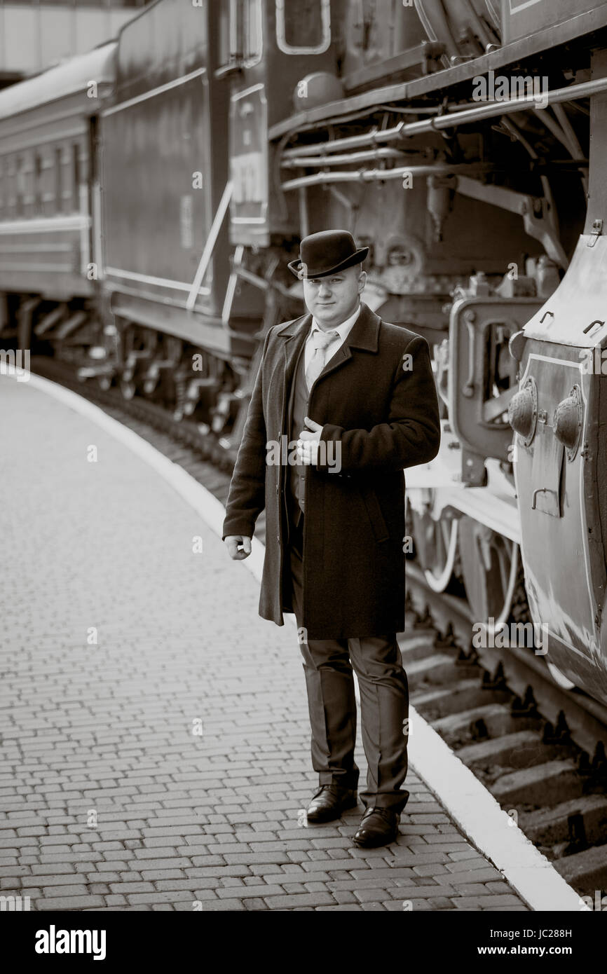 Toned retro photo of elegant man waiting on platform for train Stock ...