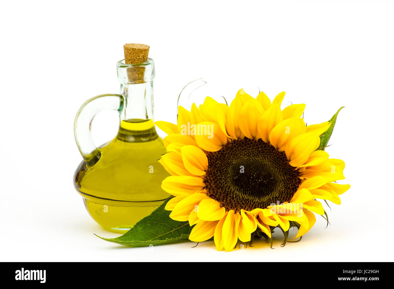 sunflower oil and sunflowers isolated on white background Stock Photo