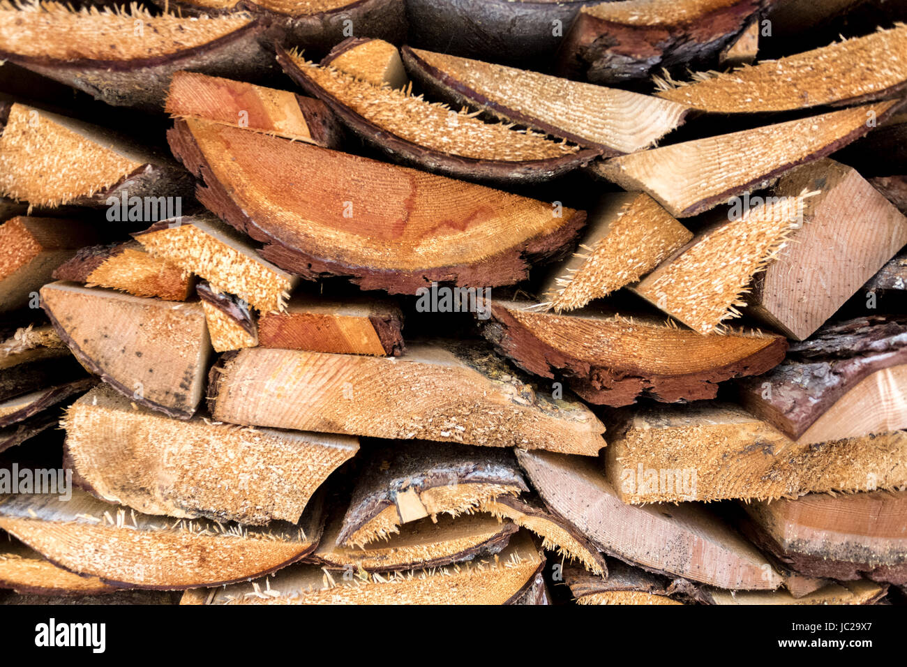 Closeup texture of freshly chopped wood planks stacked in pile Stock Photo