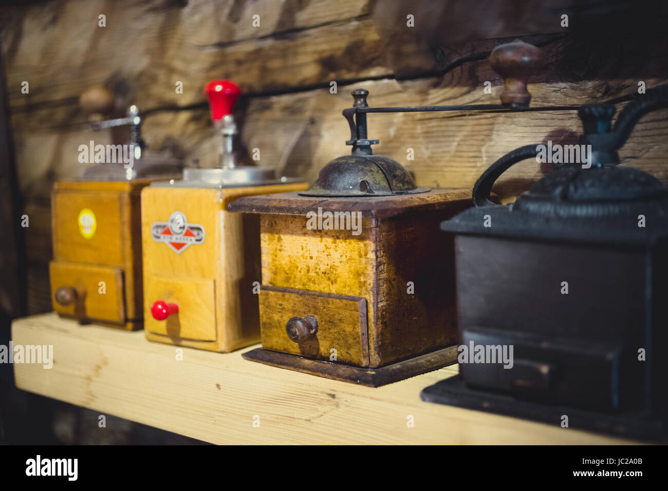Closeup photo of old manual coffee mills on wooden table Stock Photo