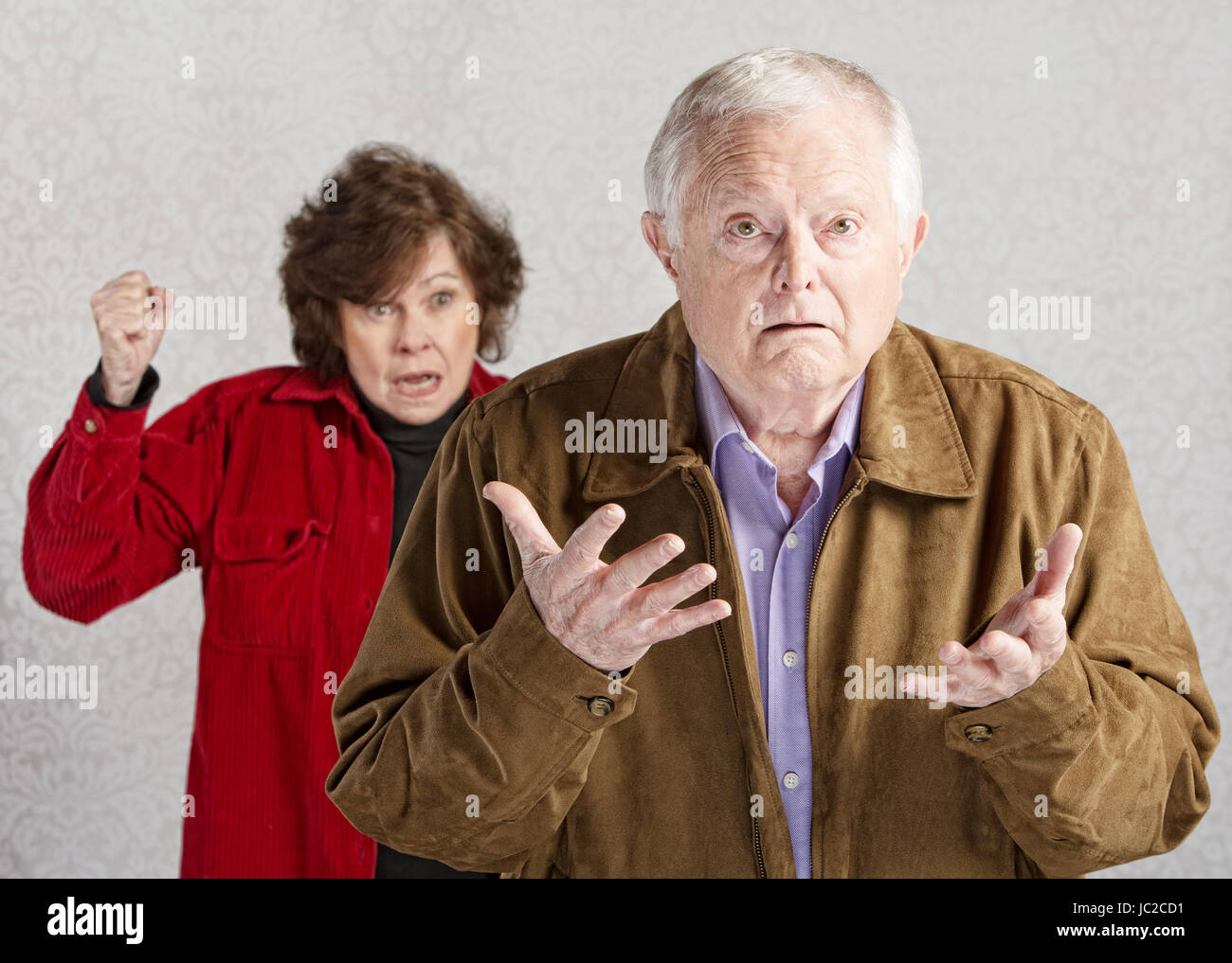 Confused elderly man with angry older woman Stock Photo