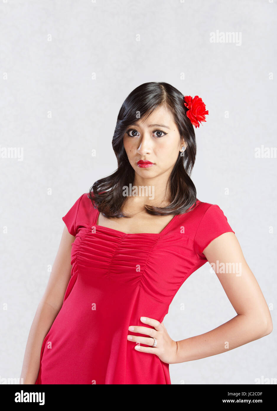 Beautiful young Asian woman with hand on hip Stock Photo - Alamy