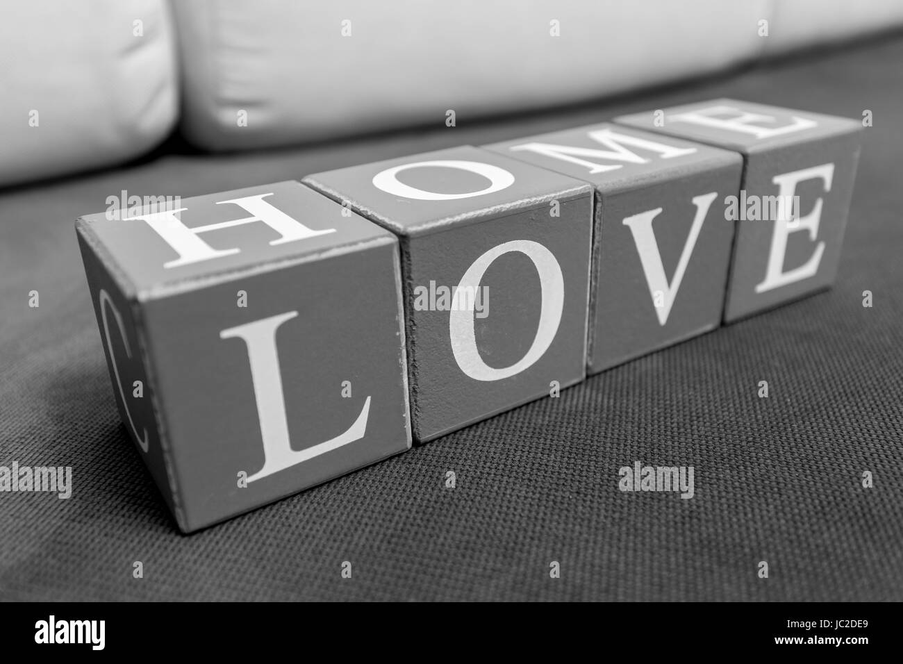 Conceptual photo of words 'home' and 'love' spelled by letters on bricks Stock Photo