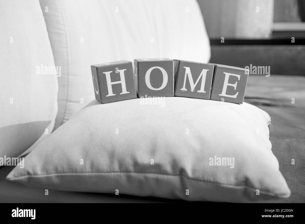 Closeup black and white photo of word home spelled on wooden cubes Stock Photo