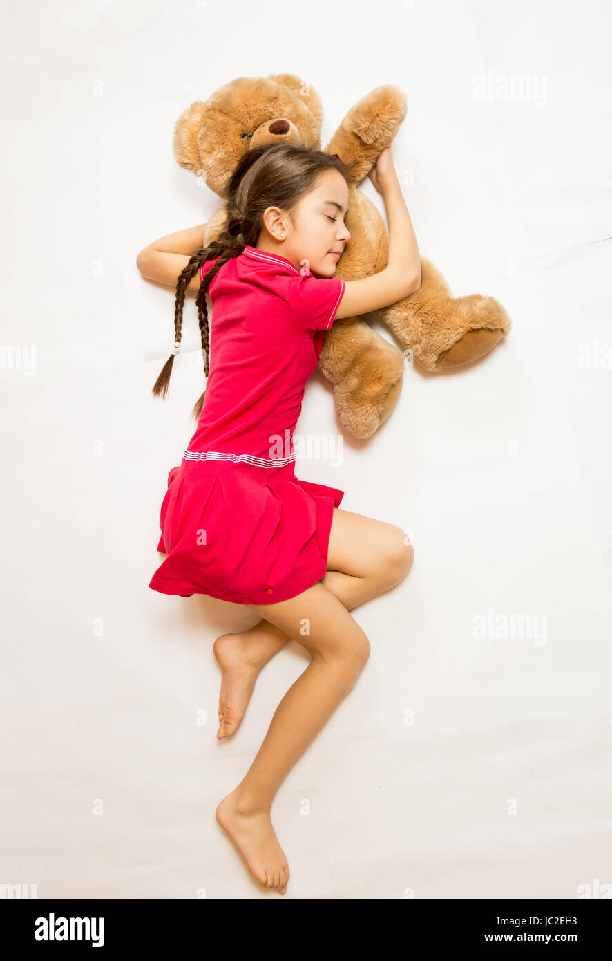 Cute Girl In Pink Dress Sleeping On Big Teddy Bear On Floor Stock Photo Alamy