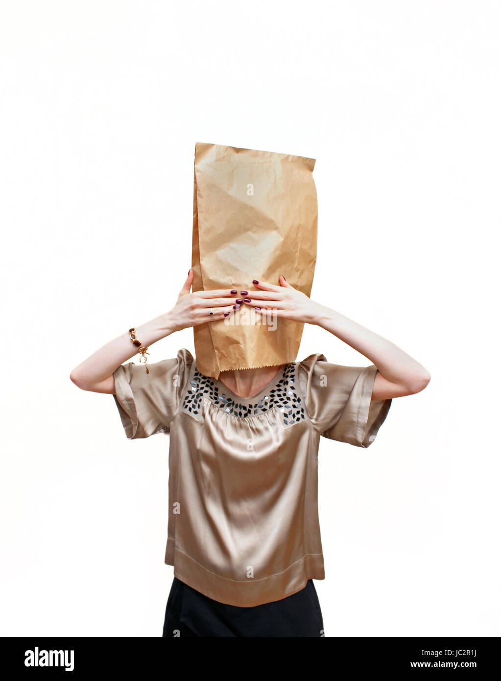 Girl with paper bag on her head and hands over eyes Stock Photo Alamy