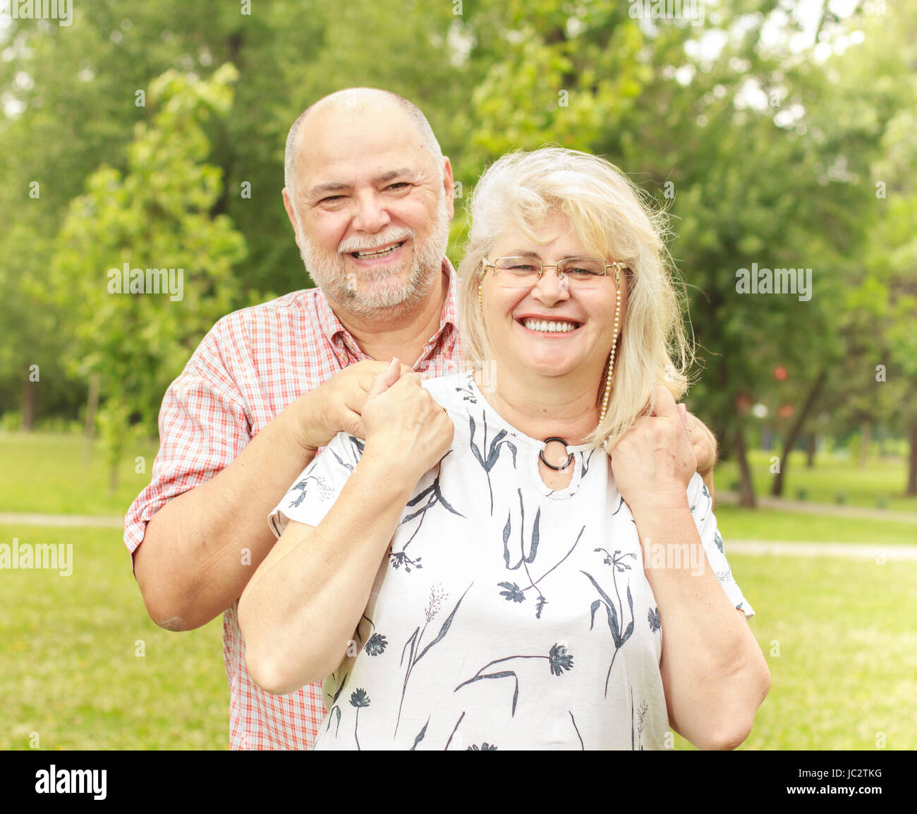 Romantic senior couple relaxing in the park Stock Photo - Alamy
