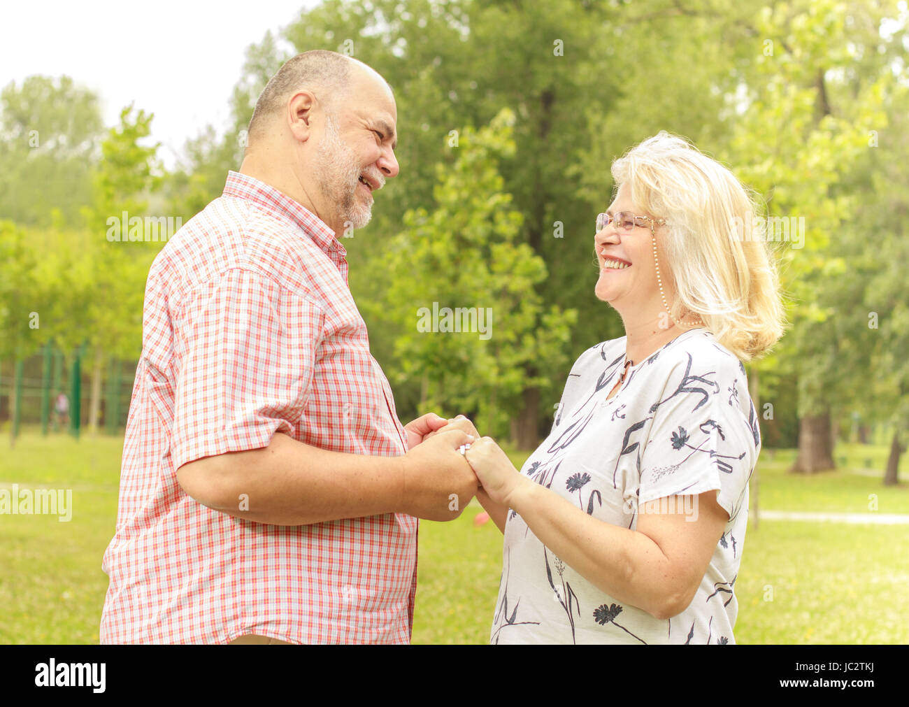 Romantic senior couple relaxing in the park Stock Photo - Alamy