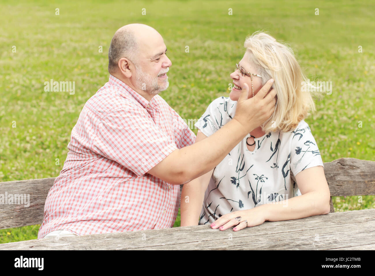Romantic senior couple relaxing in the park Stock Photo - Alamy