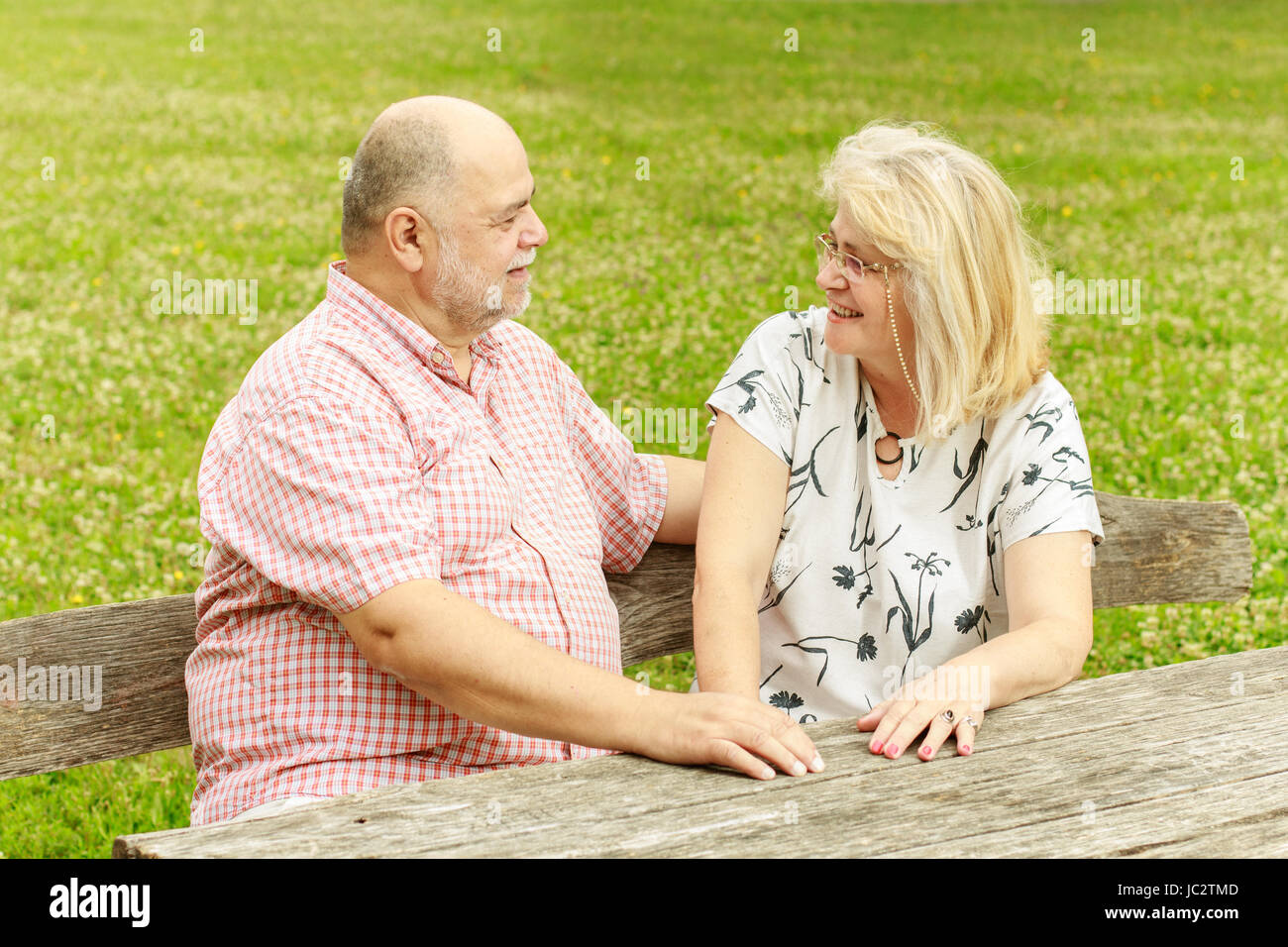 Romantic senior couple relaxing in the park Stock Photo - Alamy