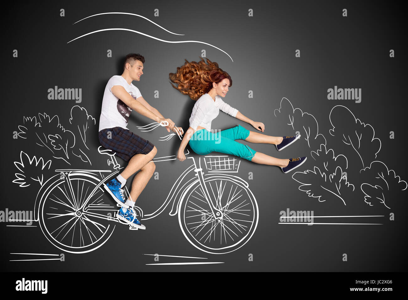 Happy valentines love story concept of a romantic couple against chalk  drawings background. Male riding his girlfriend in a front bicycle basket  Stock Photo - Alamy