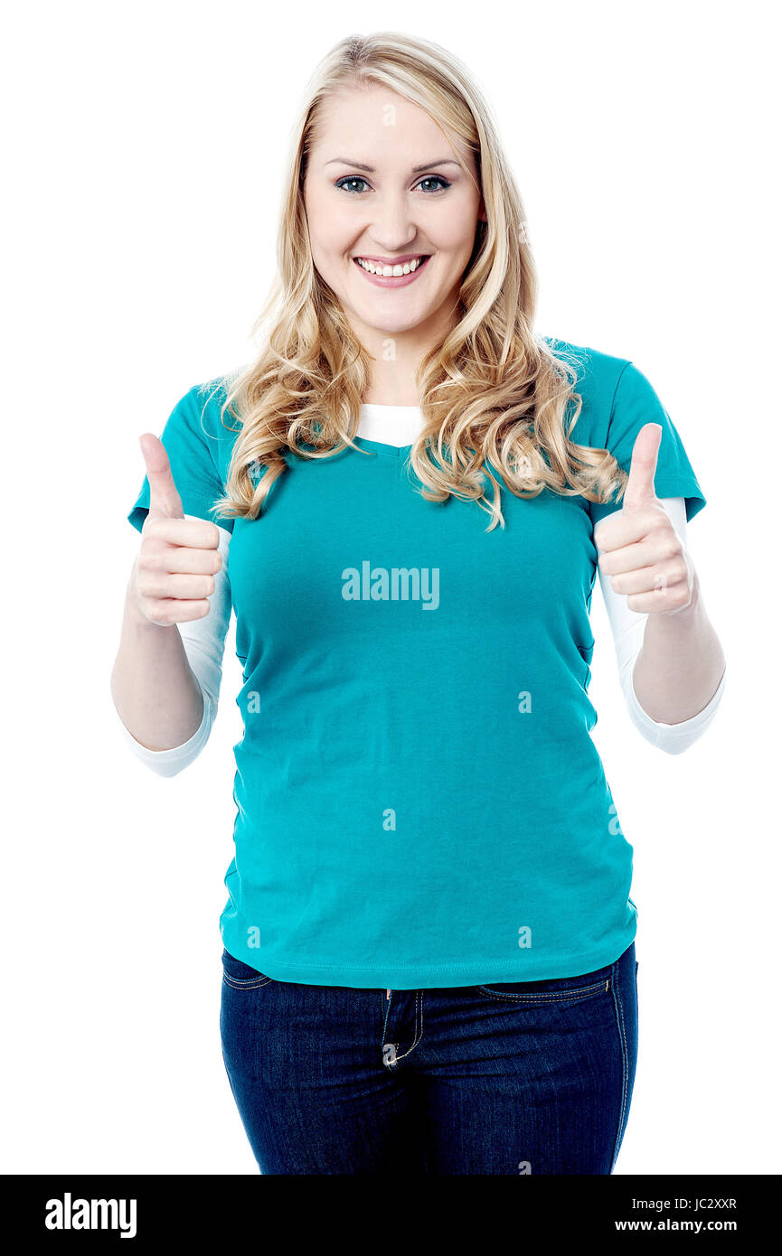 Happy young woman gesturing double thumbs up Stock Photo - Alamy