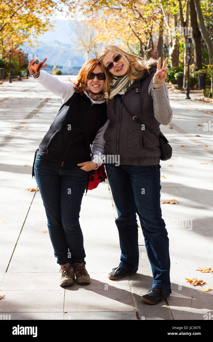 Portrait of two young happy women in park Stock Photo - Alamy