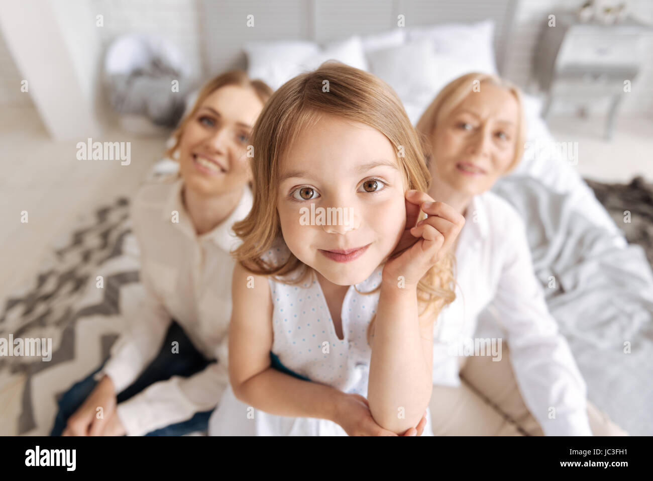 Adorable little girl looking at the camera Stock Photo - Alamy
