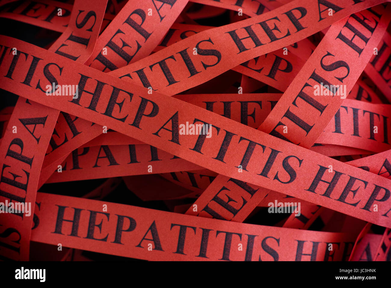 Hepatitis. Pieces of paper with the words Hepatitis. Concept Image. Closeup. Stock Photo