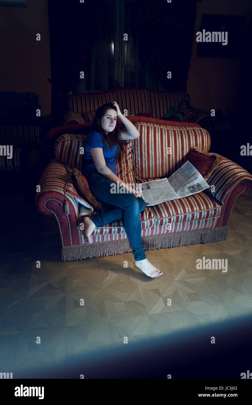 Beautiful woman watching TV show at late night Stock Photo