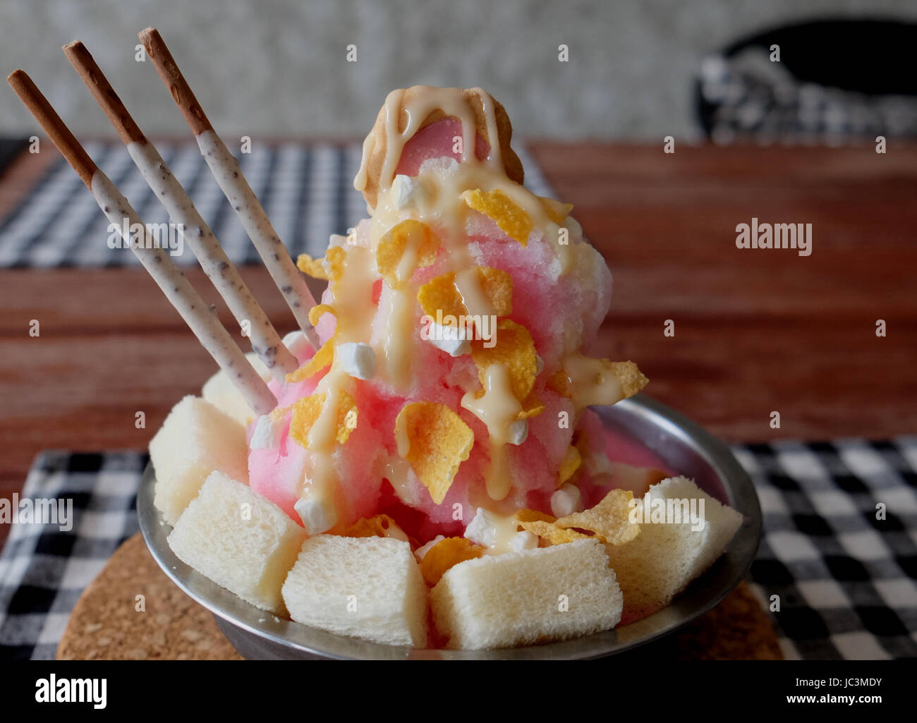 Shaved ice with syrup and milk, chocolate, strawberry Stock Photo Alamy
