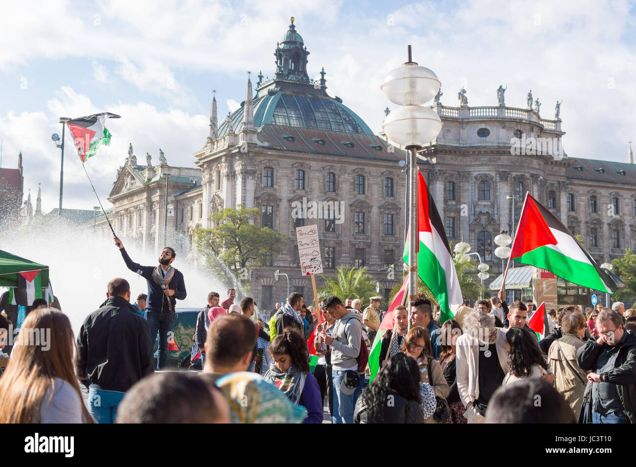 MUNICH, GERMANY - AUGUST 16, 2014: Peaceful demonstration for stopping Israel-Palestine conflict and ceasefire in Gaza Strip. Activist group calls negotiations between the warring parties. Stock Photo