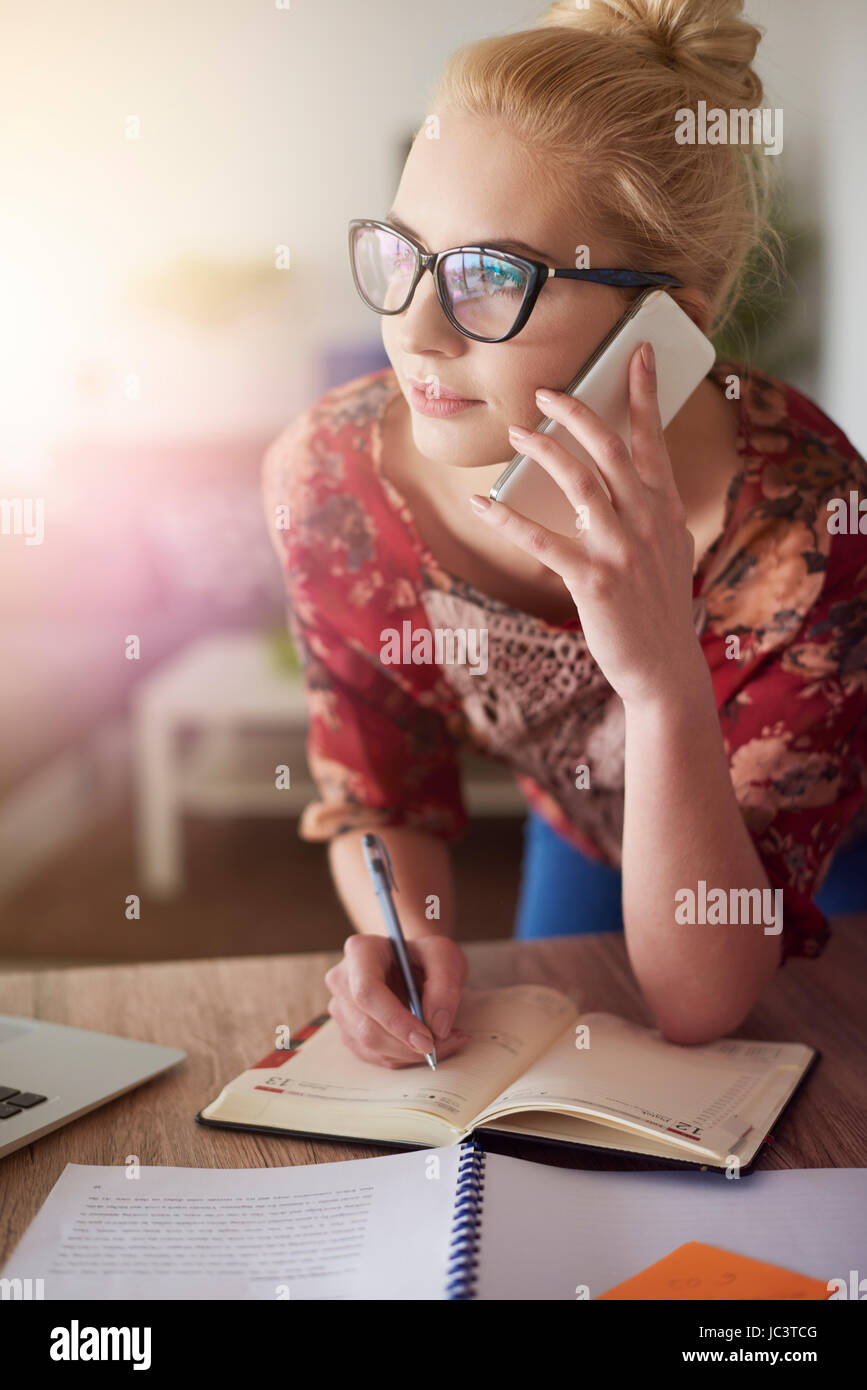 Writing down important information in the organizer Stock Photo Alamy