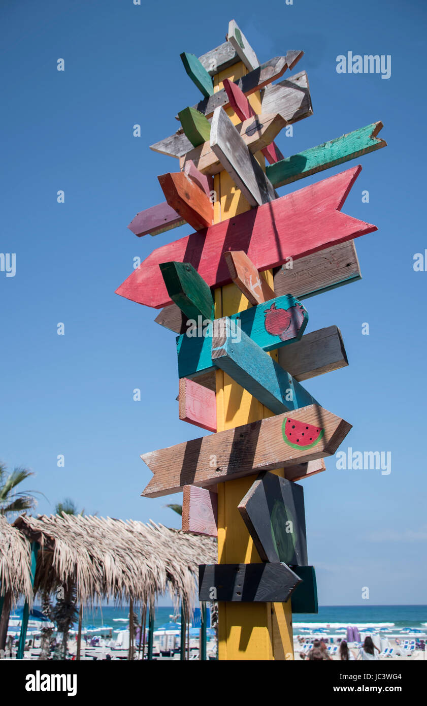 colorful sign points the way to the different destinations Stock Photo