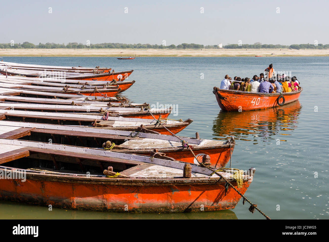 Many colorful rowing boats are tight up at Dashashwamedh Ghat, Main Ghat, in the suburb Godowlia at the holy river Ganges Stock Photo