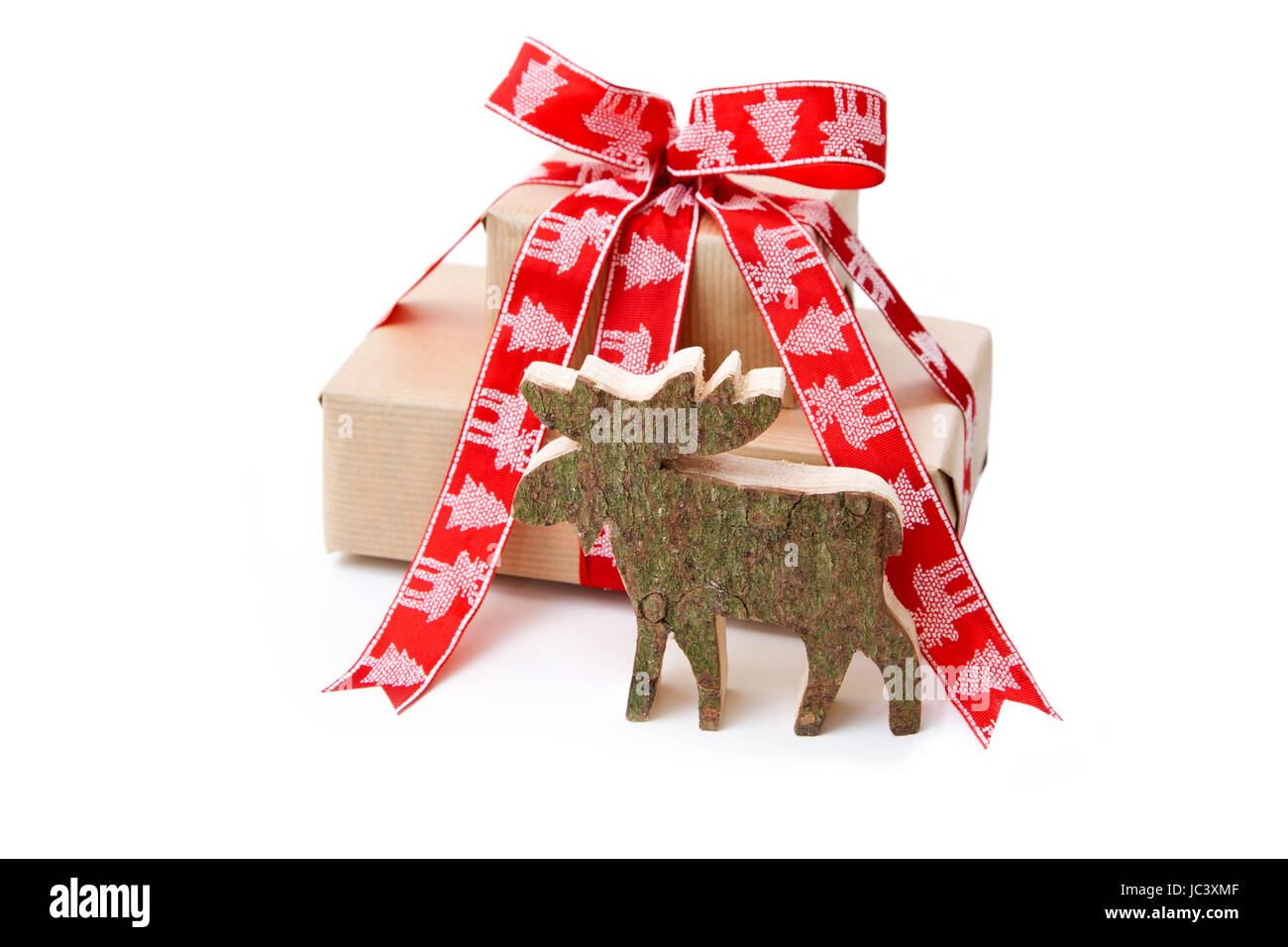 Christmas present in red with a wooden handmade elk or reindeer for decoration Stock Photo