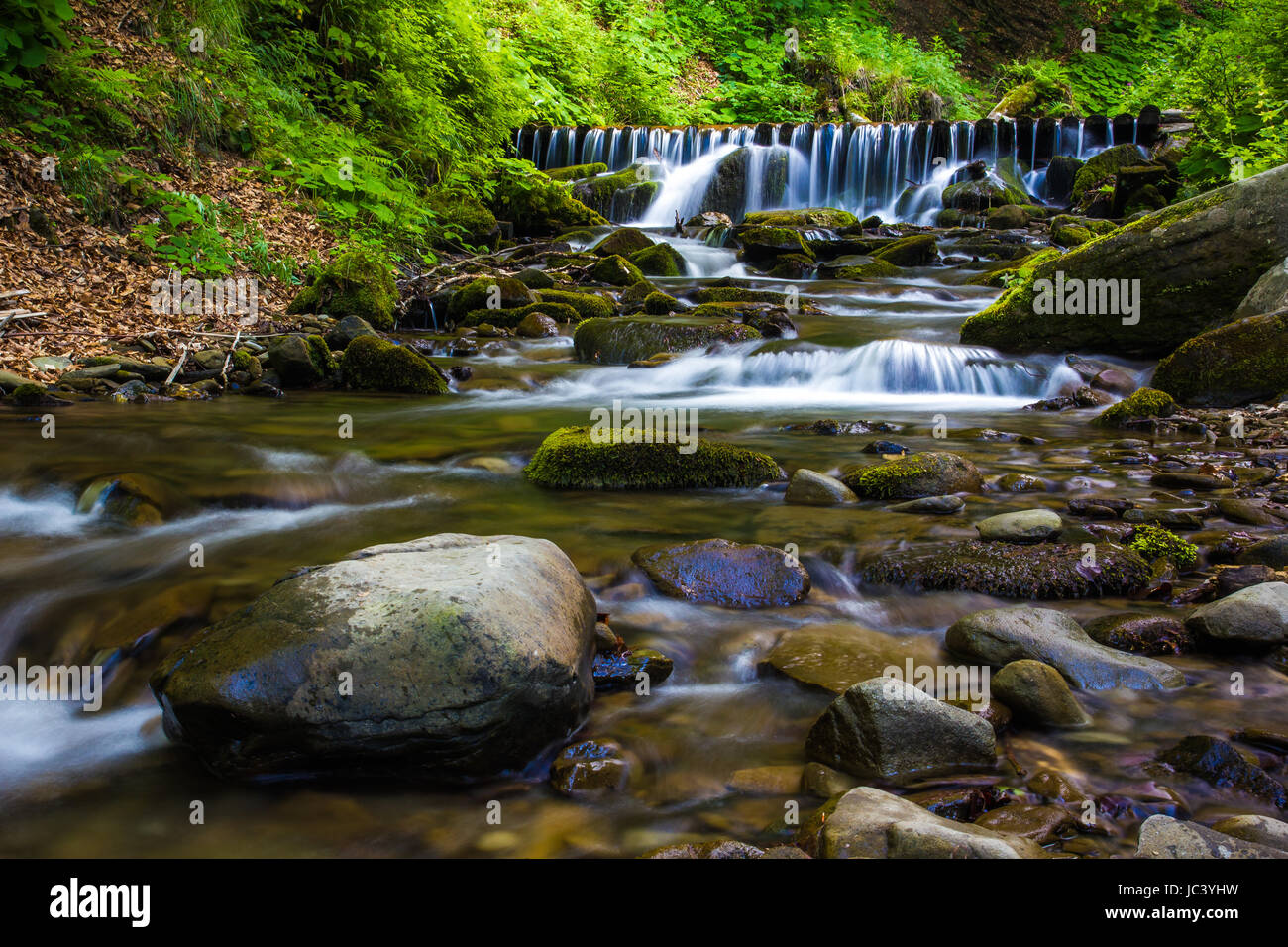Beautiful waterfall landscape (Ukrainian Carpathian ) in green forest Stock Photo