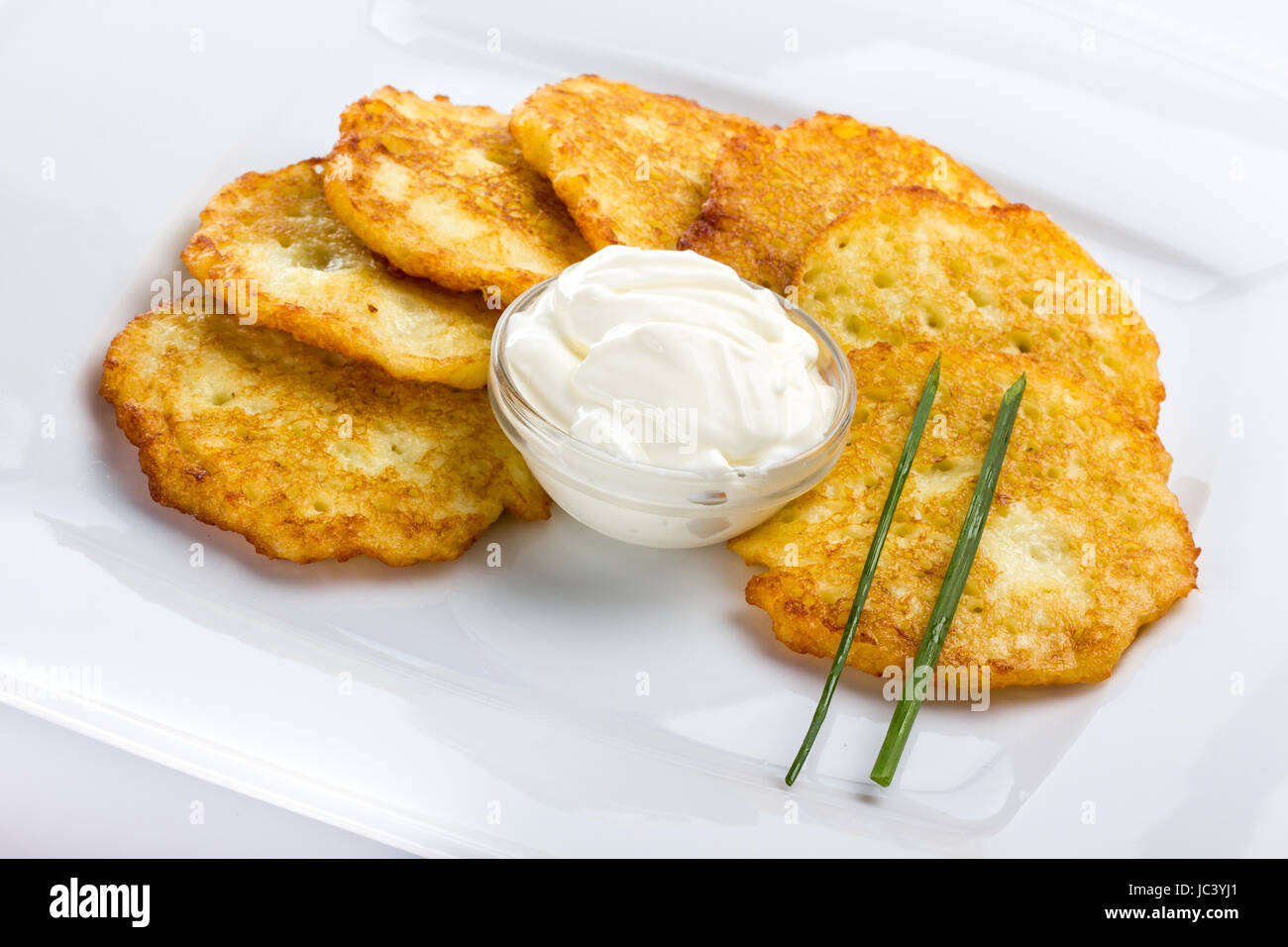 Potato Pancake with sour cream on white background Stock Photo