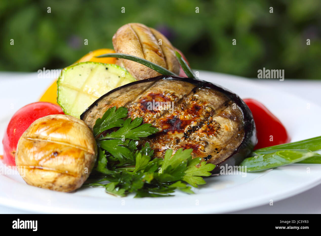 Grilled vegetables with mushrooms and greens (closeup, selective focus) Stock Photo