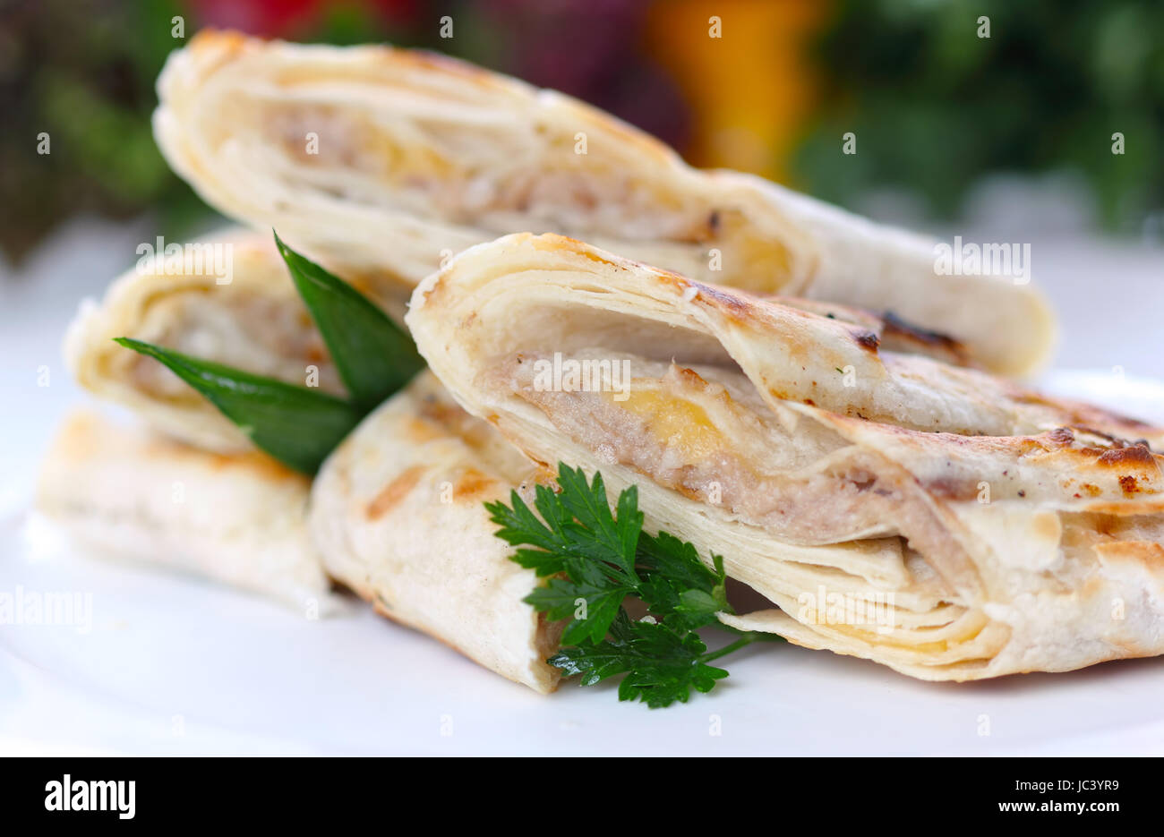 Roasted pancake with meat and greens (closeup, selective focus) Stock Photo