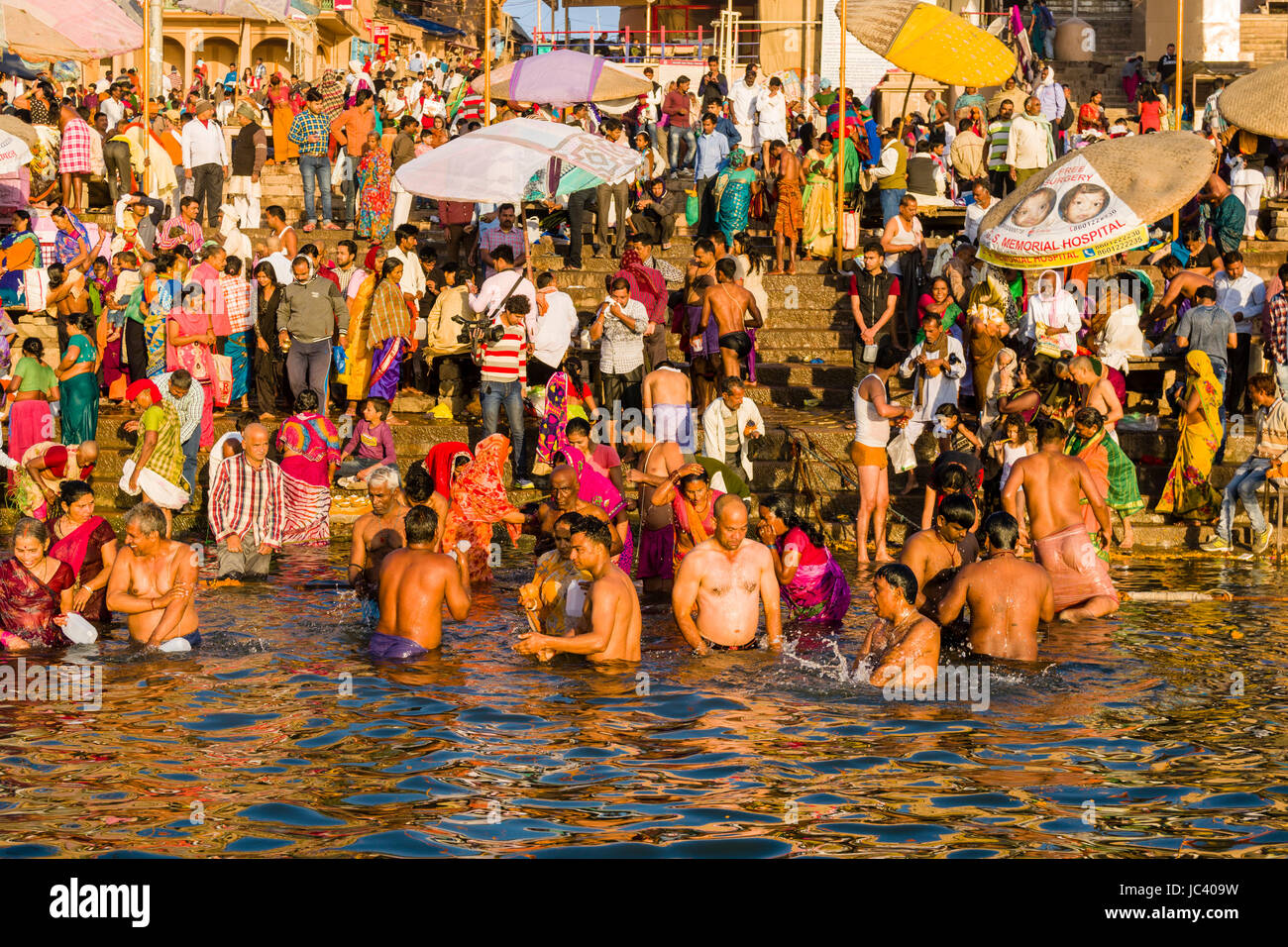 Pilgrims are taking bath in the holy river Ganges at Dashashwamedh Ghat, Main Ghat, in the suburb Godowlia Stock Photo