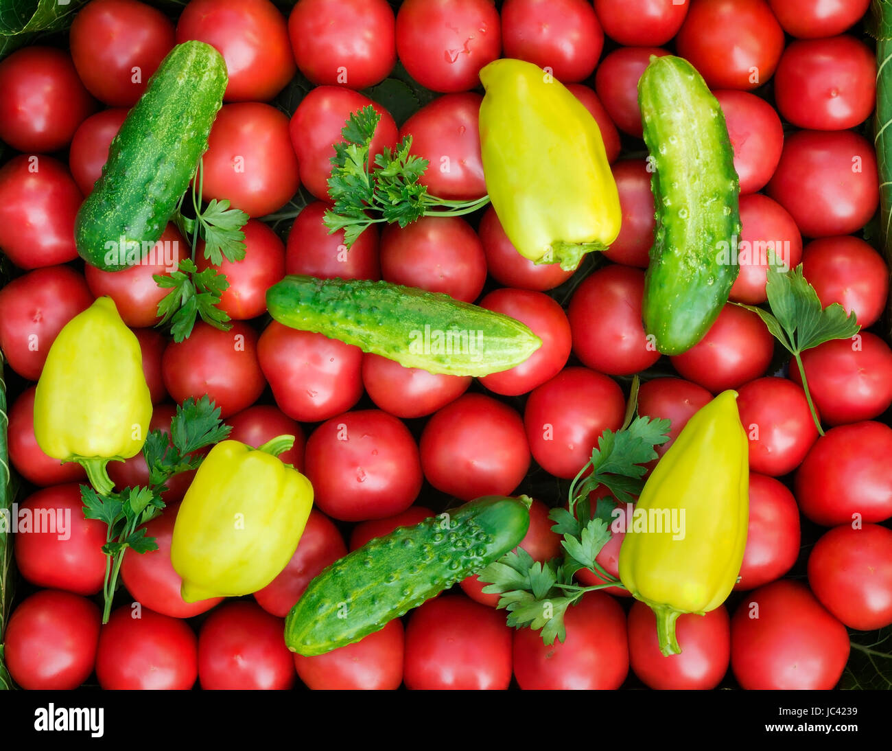 A large number mature bright red tomato, pepper, cucumbers lie on a shop show-window Stock Photo