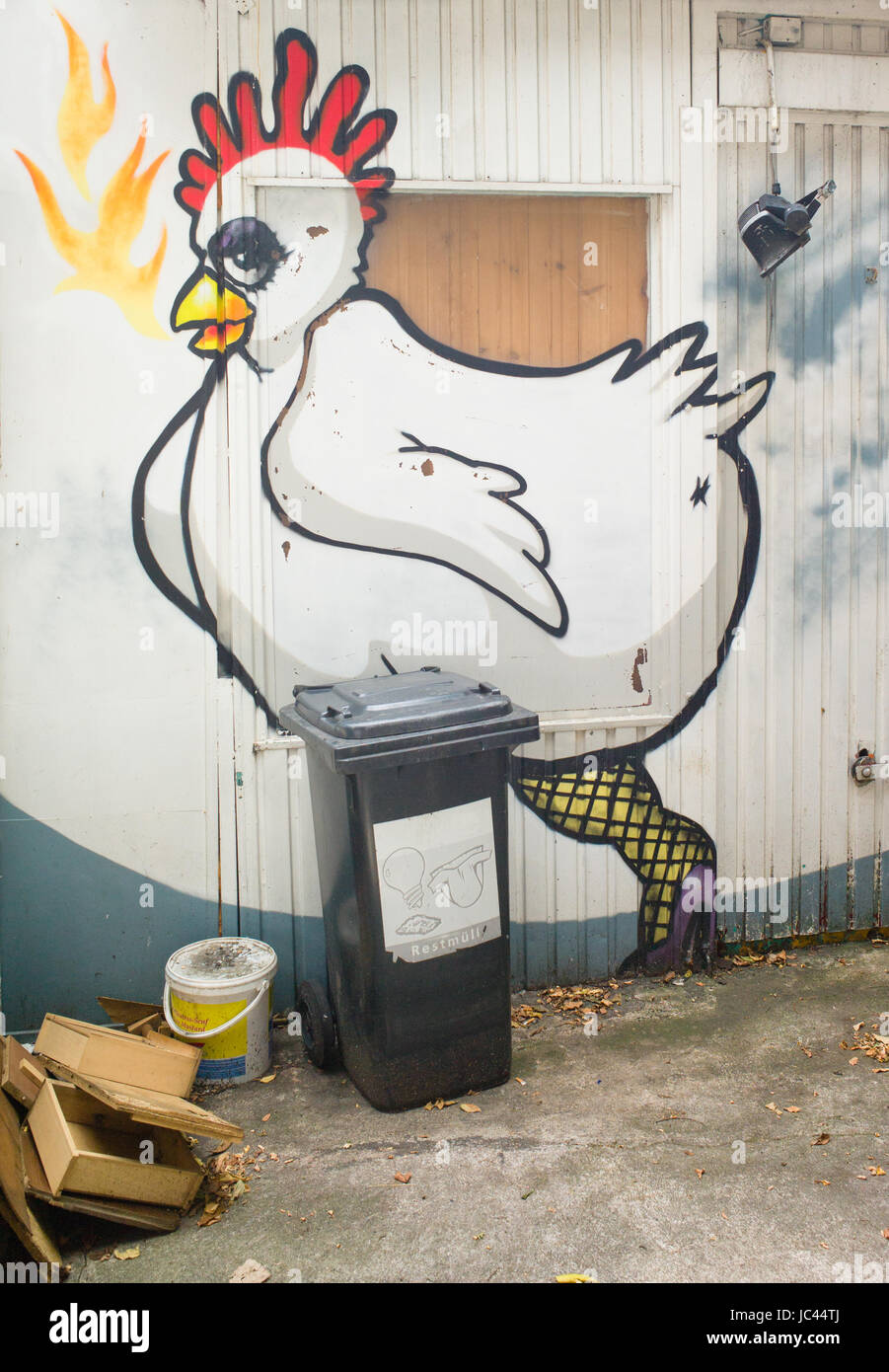 Artwork depicting chicken wearing eye shadow, fishnet stockings and high heeled shoes on outside backyard wall of restaurant, Frankfurt am Main, Germa Stock Photo